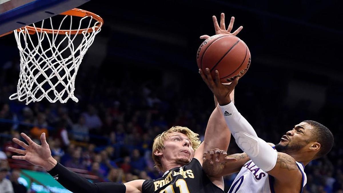 Kansas’ Frank Mason scored over Fort Hays State’s Jake Stoppel in the first half of Tuesday night's exhibition game at Allen Fieldhouse in Lawrence. The Jayhawks won 95-59.