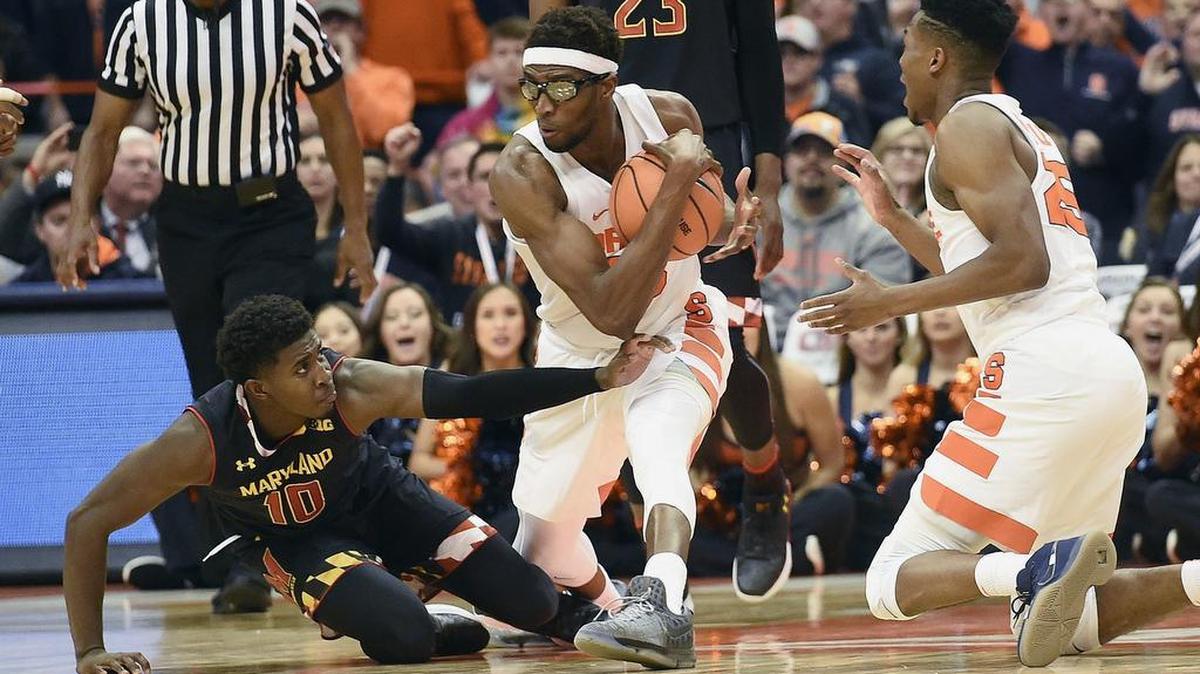 7-foot-2 Syracuse center Paschal Chukwu (13) holds on to the ball against a Maryland player during a game on Nov. 27, 2017.