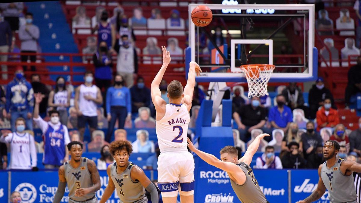 KU’s Christian Braun shoots over West Virginia’s Sean McNeil during the first half of Tuesday night’s Big 12 game at Allen Fieldhouse.
