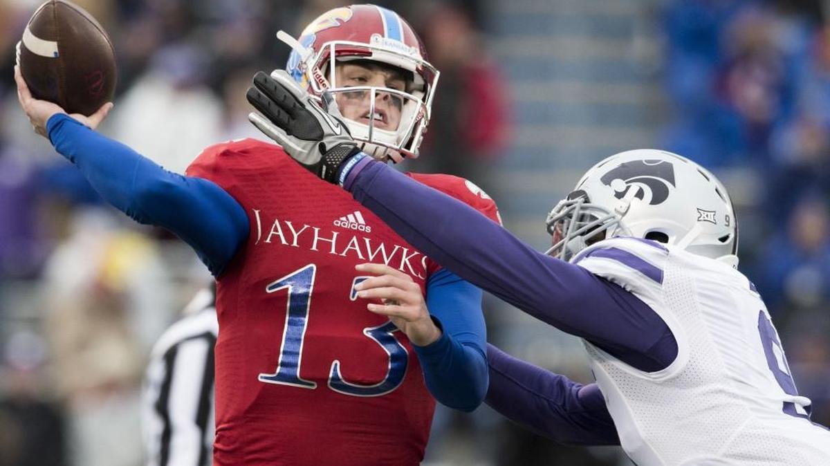 Jayhawks quarterback Ryan Willis was hurried by K-State defensive end Davis Clark in a Big 12 game in November.