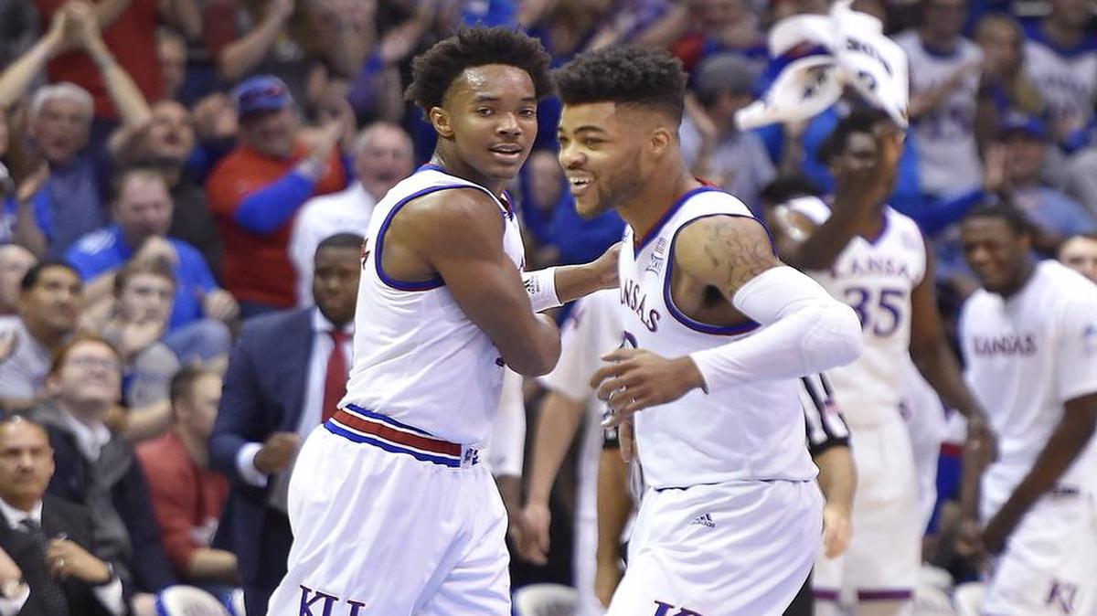 After making his fifth three-pointer of the first half in a game earlier this season, KU's Devonte' Graham (left) got a smile out of teammate Frank Mason.