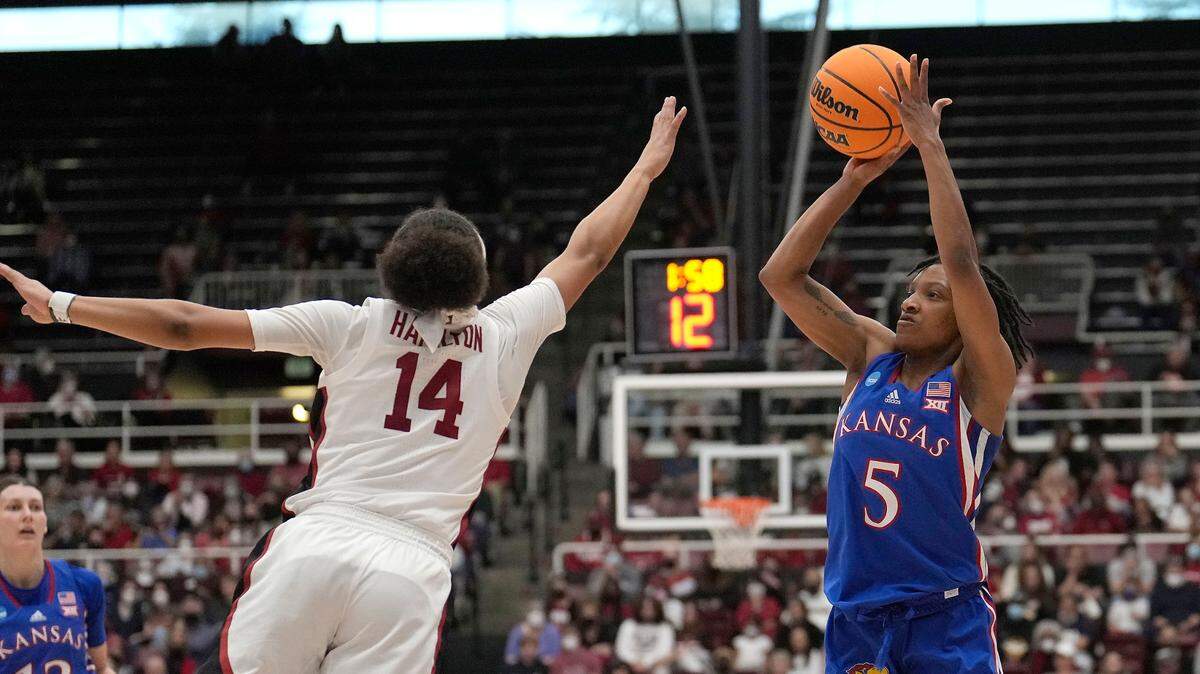 Kansas guard Aniya Thomas (5) takes a three-point shot over Stanford guard Jordan Hamilton (14) during the first half of a second-round game in the NCAA women’s college basketball tournament Sunday, March 20, 2022, in Stanford, Calif.
