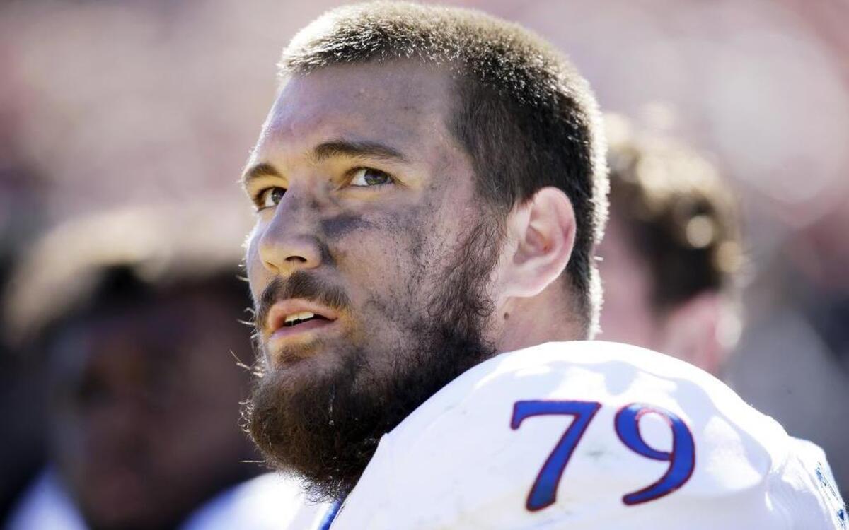 Kansas offensive lineman Jordan Shelley-Smith is retiring from football due to concussions.