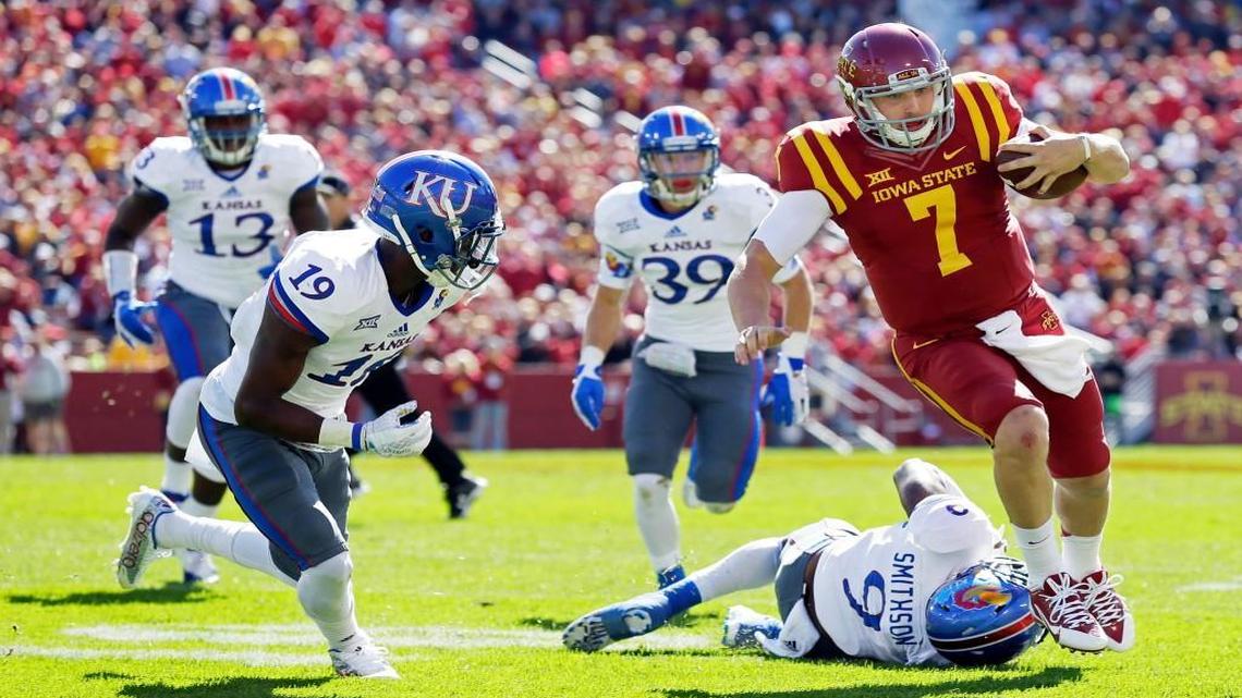 
Iowa State quarterback Joel Lanning ran from Kansas defenders Tyrone Miller Jr. (let) and Fish Smithson during Saturday’s Big 12 football game in Ames.
