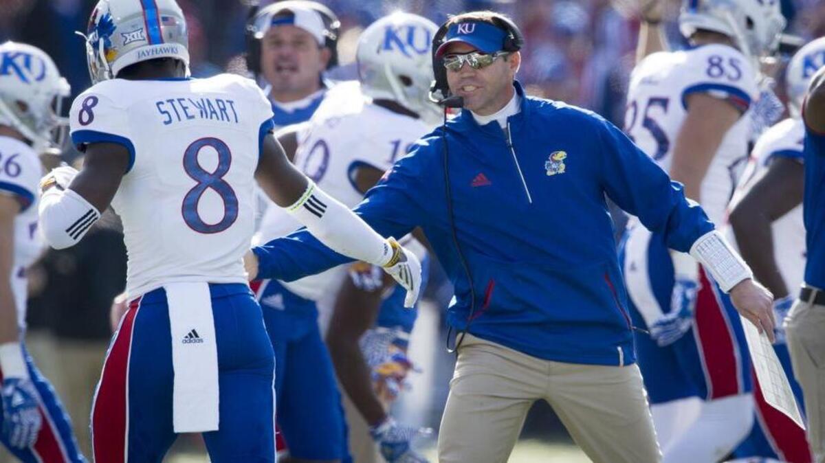 It could cost Kansas a lot of money if it wanted to replace defensive coordinator Clint Bowen (right) or offensive coordinator Doug Meacham.