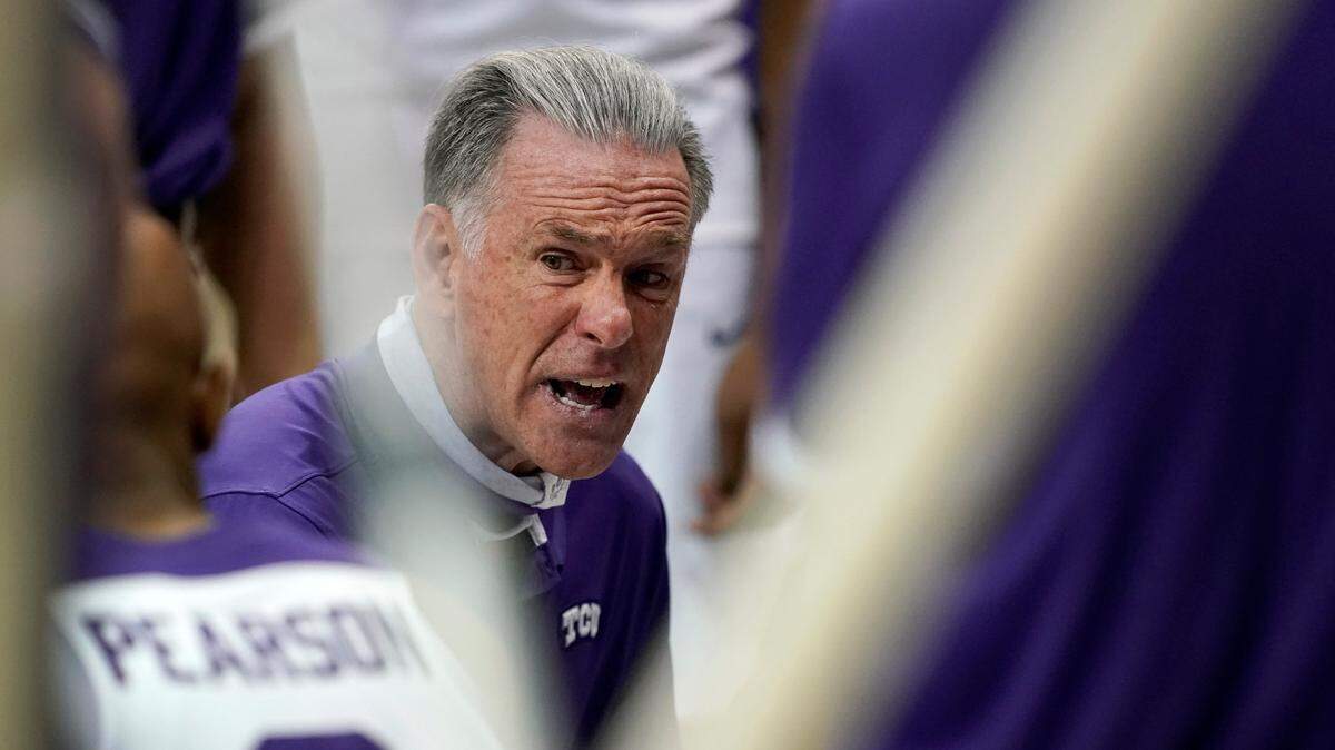 TCU head coach Jamie Dixon talks to forward Mickey Pearson (2) and the rest of the team during a time out in the second half of a college basketball game against Northwestern State in Fort Worth, Texas, Thursday, Dec. 3, 2020.