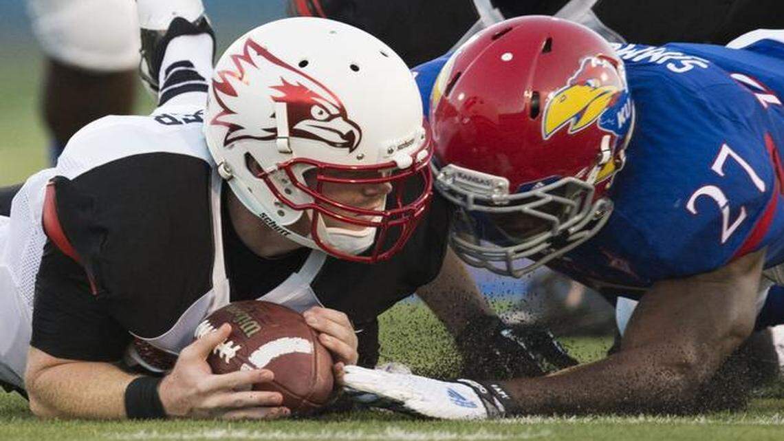 
Southeast Missouri State quarterback Kyle Snyder (left) and the Jayhawks’ Victor Simmons dived for a loose ball during their game in September.

