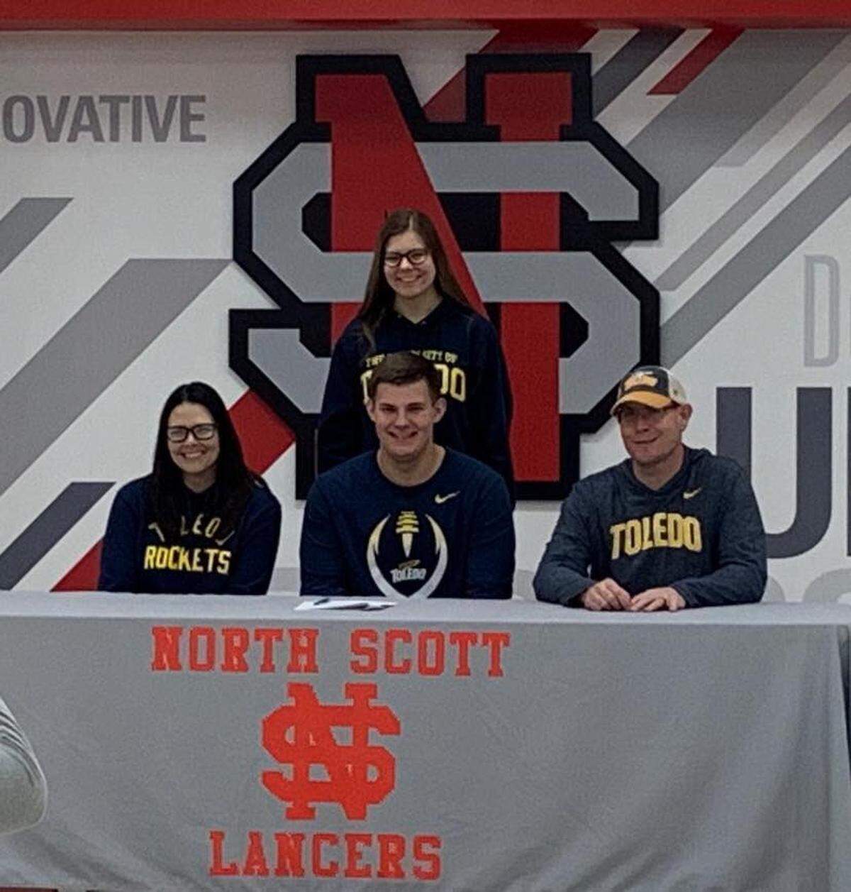 Former Kansas commitment Jackson Stoefen, middle front, smiles during a Signing Day ceremony with his mother Anne, sister Joie and father Jake.
