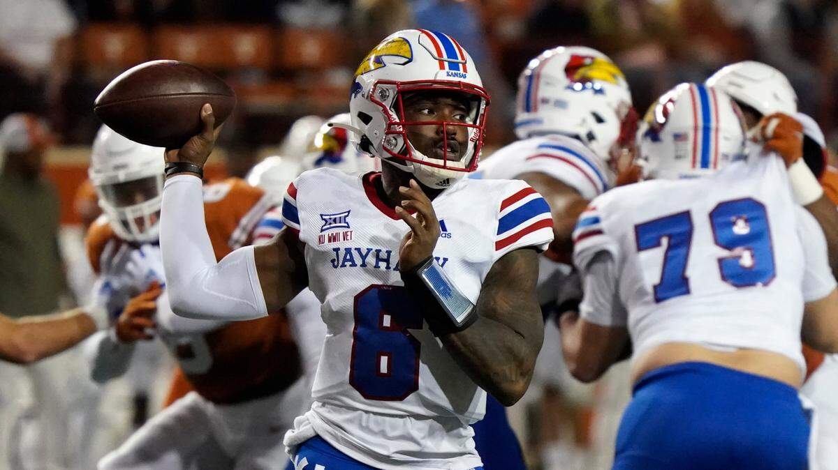Kansas quarterback Jalon Daniels (6) looks to pass against Texas during the first half of a game in Austin, Texas, Saturday, Nov. 13, 2021.