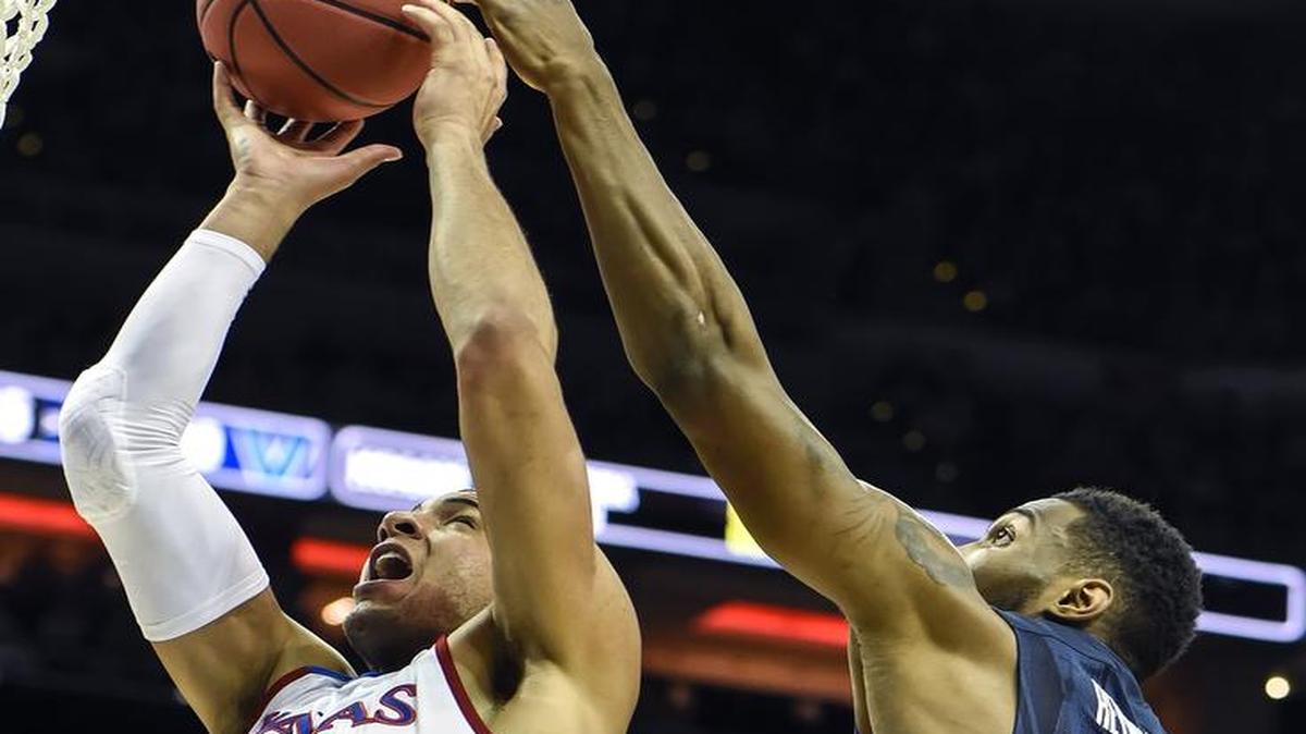 Jayhawks forward Landen Lucas grabbed a rebound in front of Villanova’s Darryl Reynolds in an NCAA Tournament game in Louisville, Ky., in March.