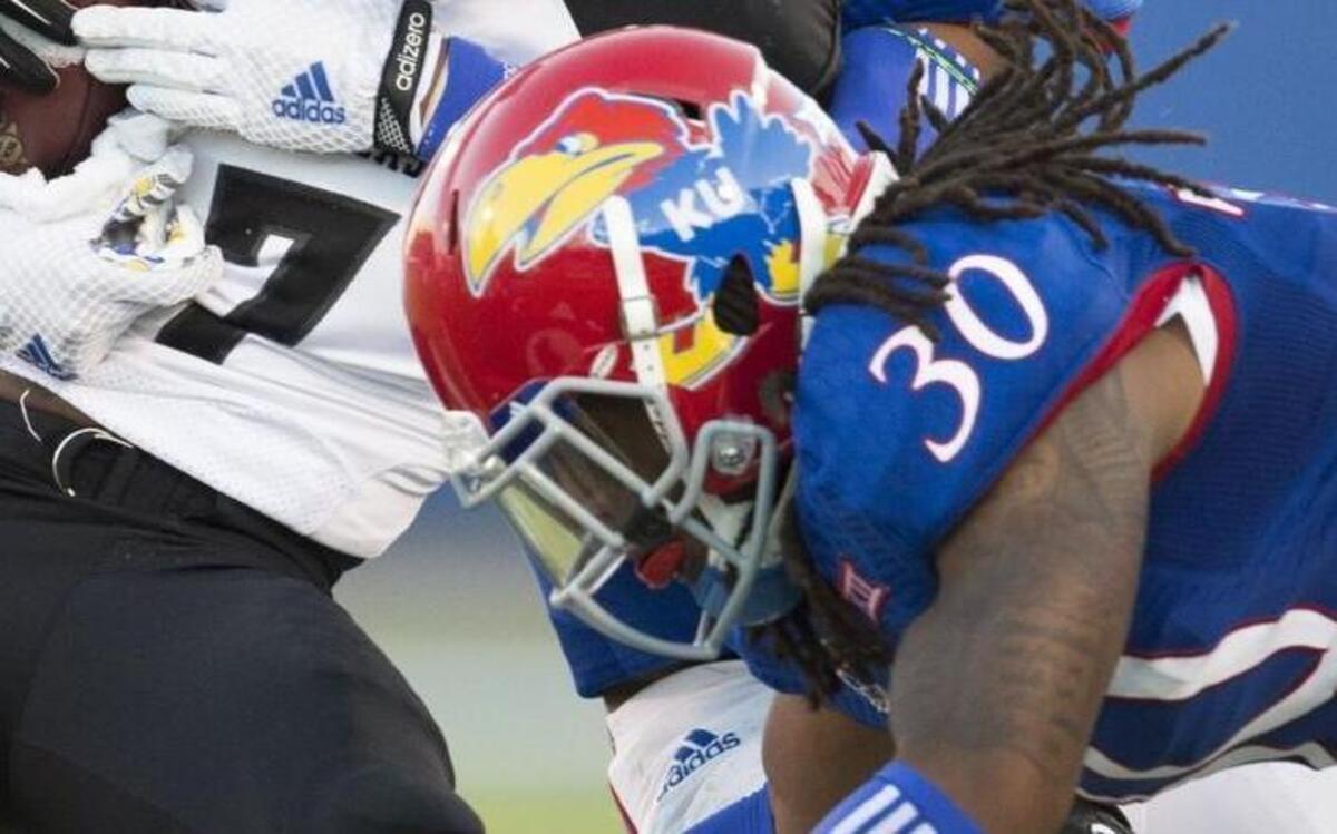 
Kansas nickel back Tevin Shaw (foreground) joined safety Anthony Smithson in hitting Southeast Missouri State wide receiver Peter Lloyd during a game last year. Shaw will be going home as the Jayhawks take on Rutgers in New Jersey this weekend.
