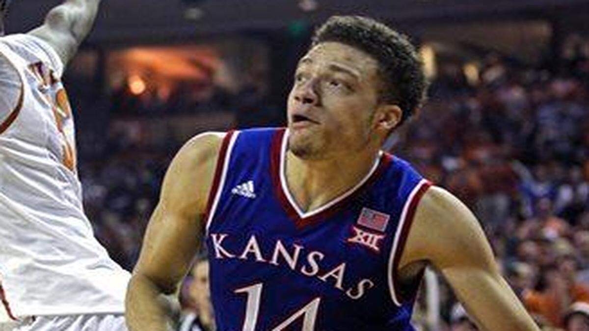 
Kansas’ Brannen Greene drove around Texas forward Myles Turner in the first half Saturday. But Greene did most of his damage from long range, hitting four of five three-pointers.
