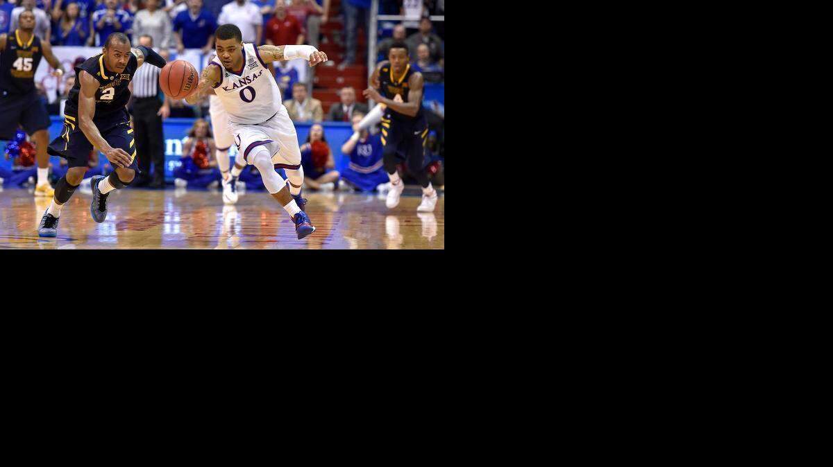 
KU's Frank Mason (0) was the man of the hour as he made plays like this steal on West Virginia's Jevon Carter late in the Jayhawks 76-69 overtime win Tuesday night at Allen Fieldhouse.
