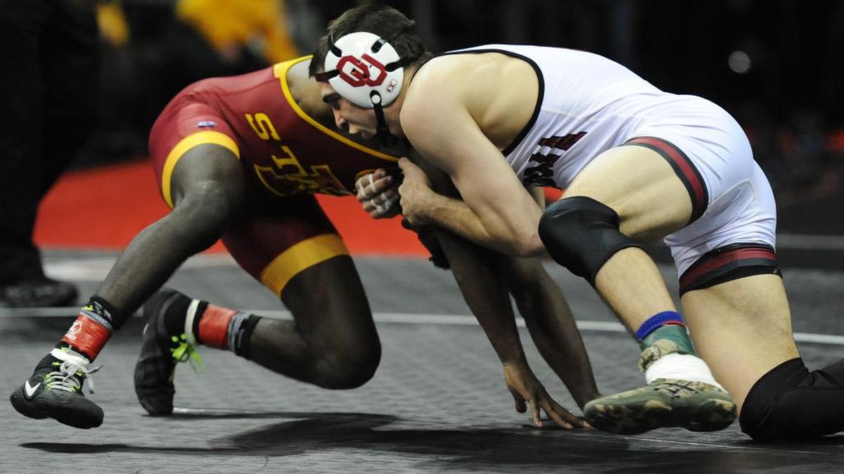 Oklahoma’s Cody Brewer (right) grappled and defeated Iowa State’s Earl Hall in the 133-pound class finals match at the Big 12 Wrestling Championships at the Sprint Center.