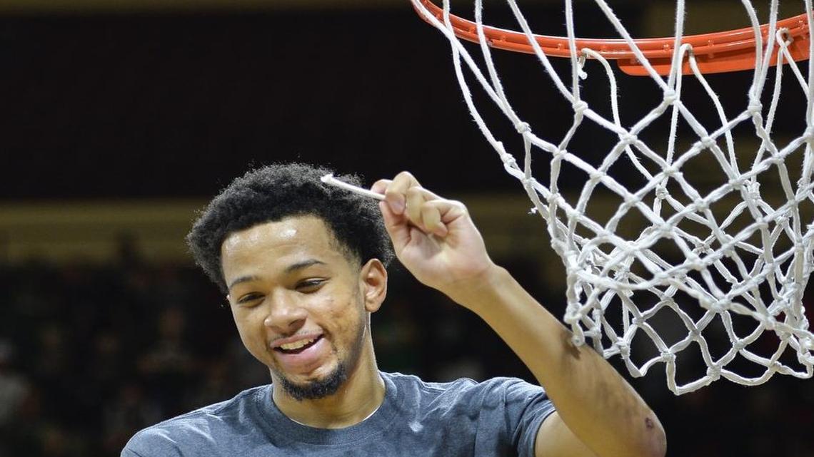 Justin Pitts of Northwest Missouri State University helped cut down the net after beating University of Central Missouri 69-61 in the MIAA Tournament Championship Game at Municipal Auditorium in Kansas City.