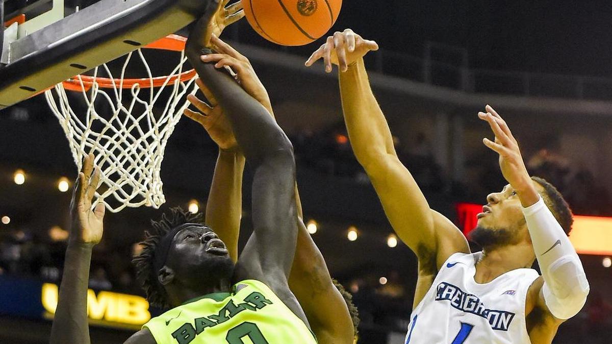 Baylor Bears forward Jo Lual-Acuil Jr. (0) and Creighton Bluejays guard Davion Mintz (1) fought for a rebound on Tuesday during the second half of the 2017 Hall of Fame Classic championship game at the Sprint Center in downtown Kansas City. Baylor won 65-59.