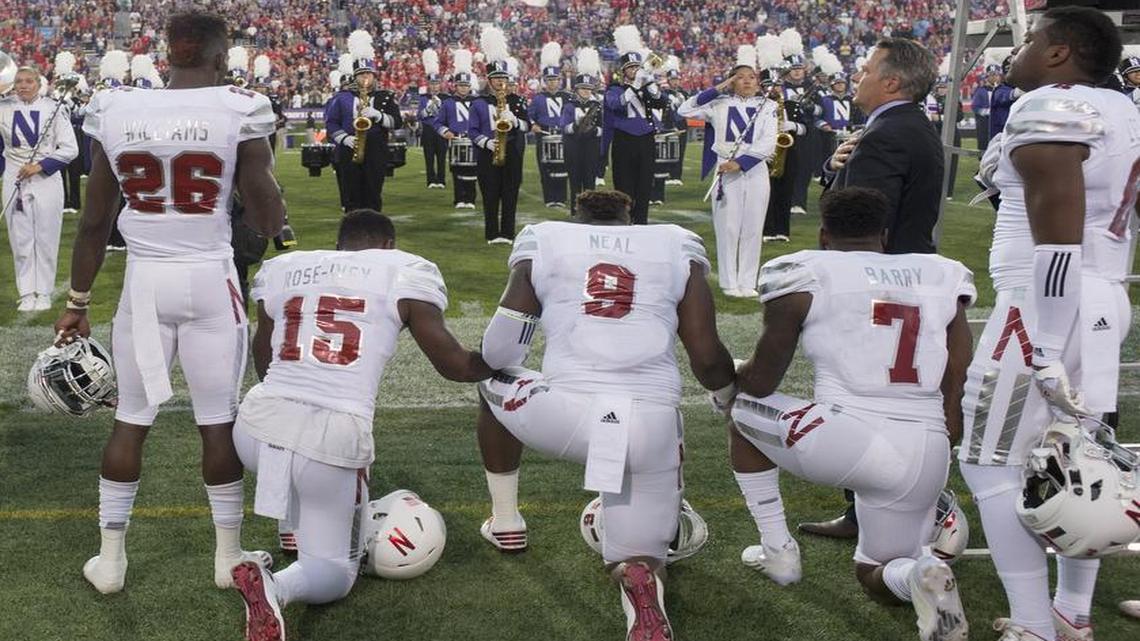 Nebraska linebacker Michael Rose-Ivey (third from left), a former Rockhurst High player, defensive end DaiShon Neal and linebacker Mohamed Barry knelt during the national anthem before the Huskers’ game Saturday against Northwestern in Evanston, Ill. Rose-Ivey said Monday he and his family have received racially charged criticism on social media, and said the responses show why the protest was necessary.