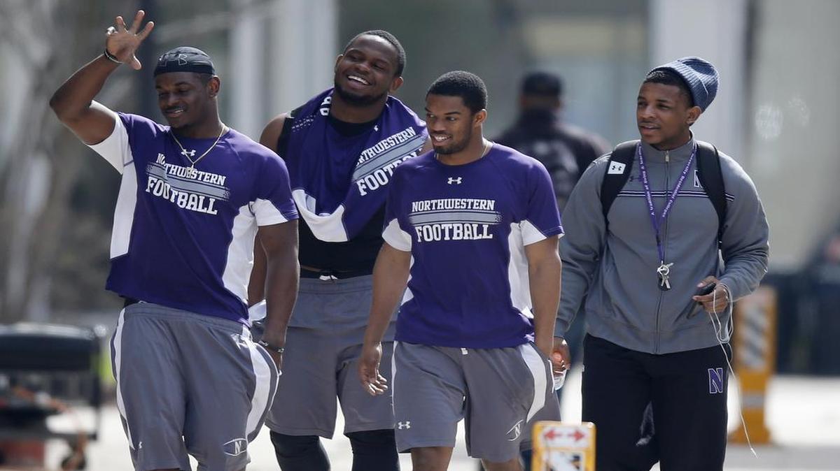 
In this April 25, 2014, file photo, Northwestern football players walk between their locker room and McGaw Hall, where they voted to form a union. But the NLRB ruled Monday that they are not university employees and cannot do so.
