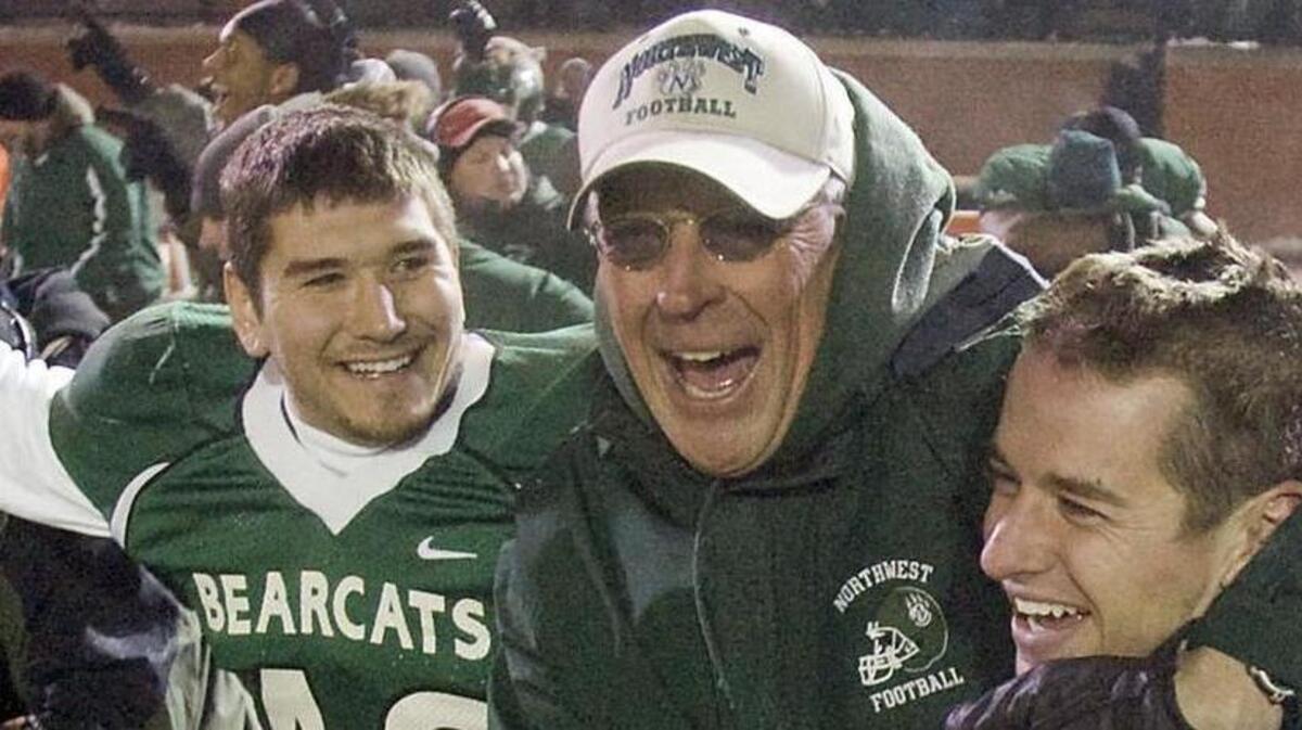 Gerrit Hane, coach Mel Tjeerdsma and Chris Termini hug following Northwest Missouri’s victory over Grand Valley State in the 2007 NCAA Division II semifinals at Bearcat Stadium in Maryville, Mo.
