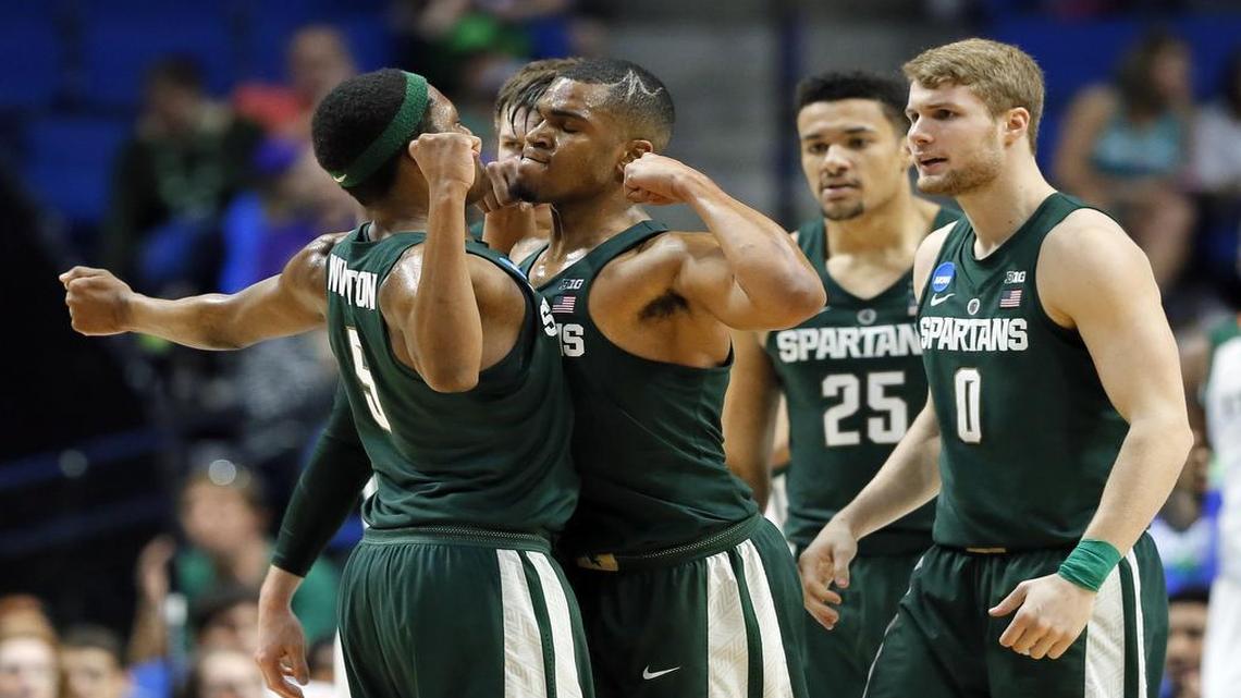 Michigan State guard Cassius Winston (left) and guard Alvin Ellis III (center) celebrated a basket as the Spartans got things going on Friday against Miami in Tulsa, Okla., in the NCAA Tournament.