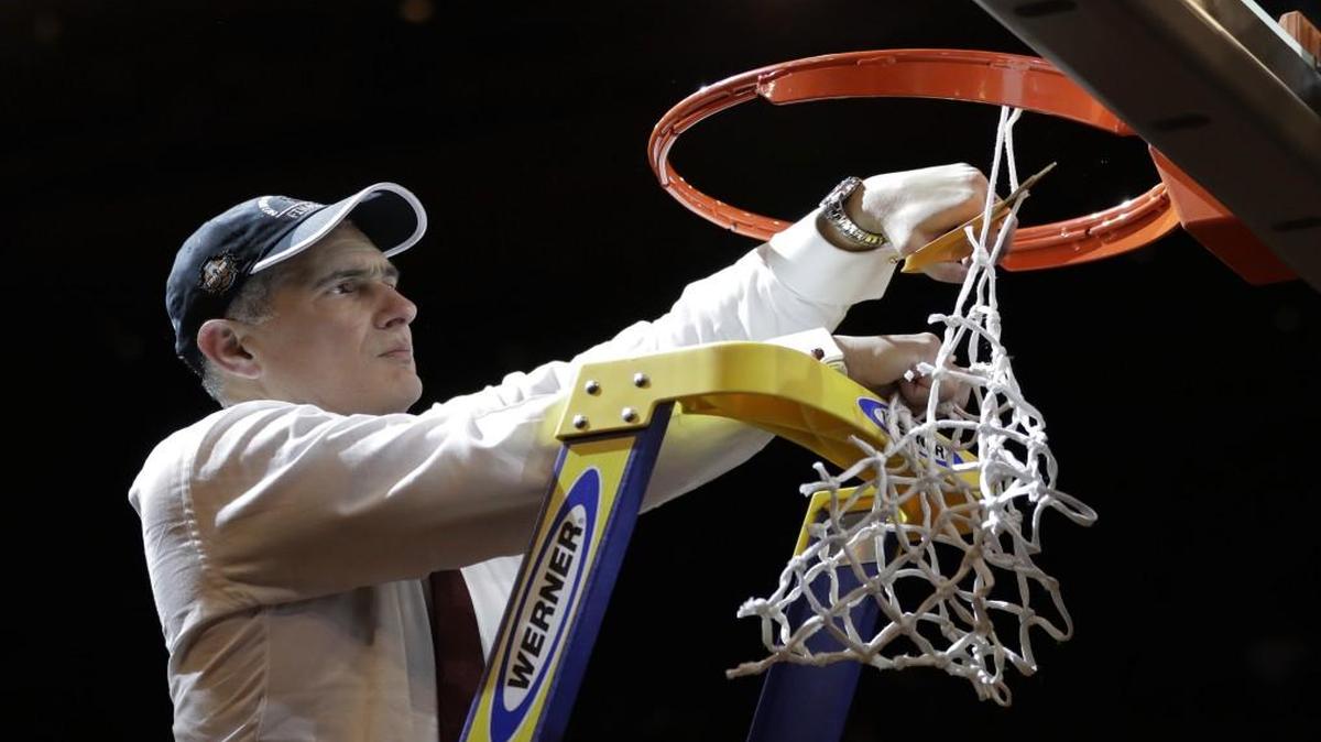 South Carolina head coach Frank Martin cut down the net after beating Florida 77-70 in the East Regional championship game.
