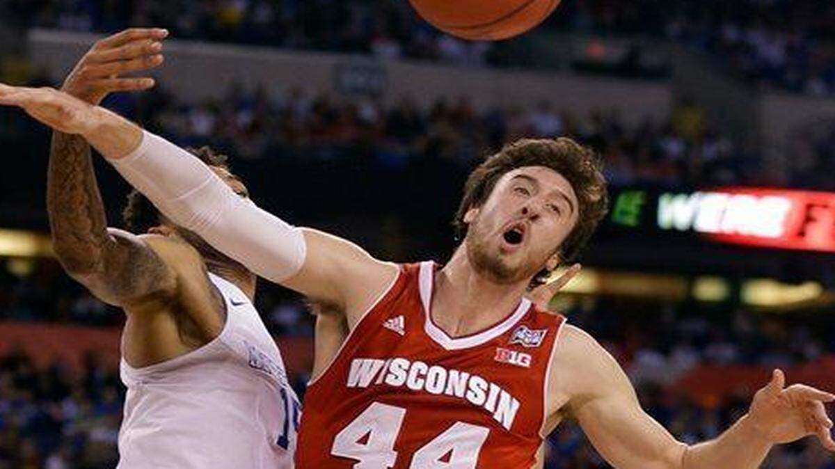 
Wisconsin’s Frank Kaminsky (right) gets to play for a national title after sticking around for his senior season.

