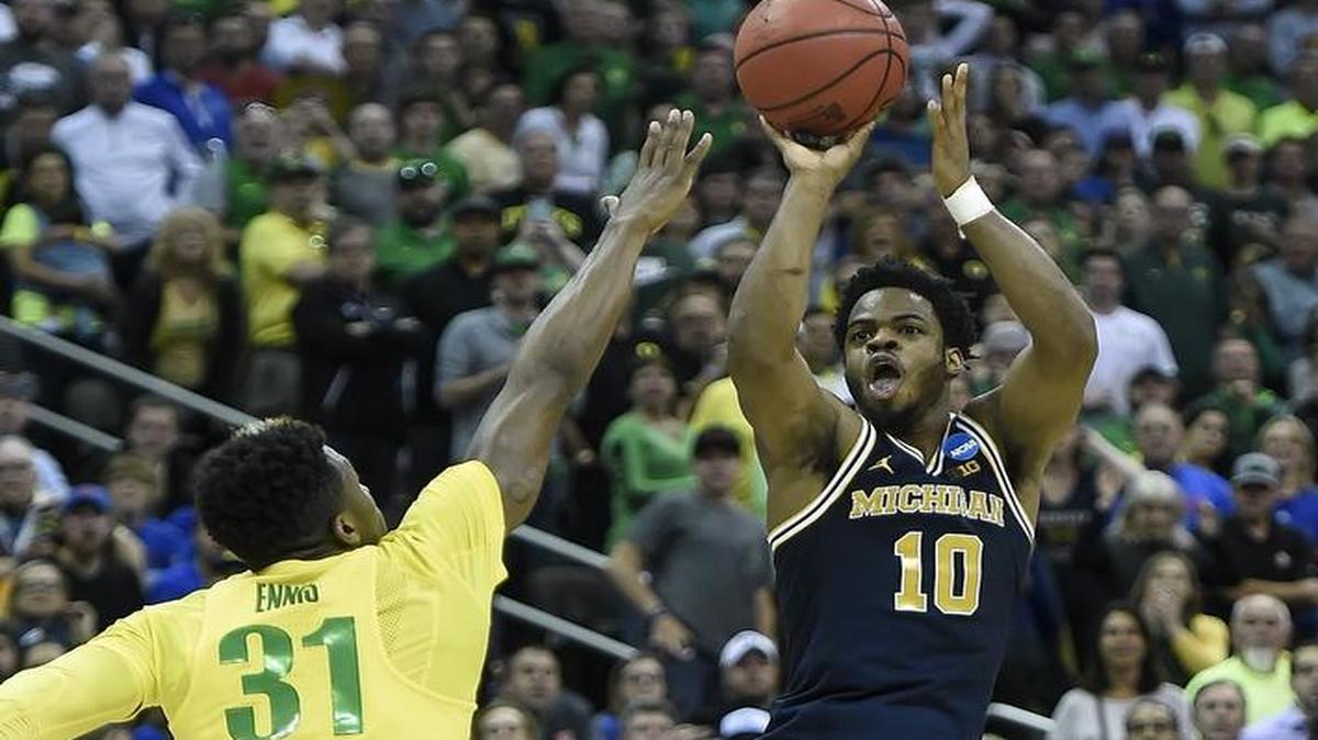 Michigan guard Derrick Walton Jr. got off a shot against Oregon guard Dylan Ennis that could have won the game, but it missed in the Ducks’ 69-68 win Thursday in an NCAA Tournament Sweet 16 game at the Sprint Center.