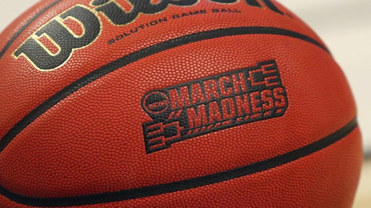 A closeup view of an official game ball with the March Madness logo.