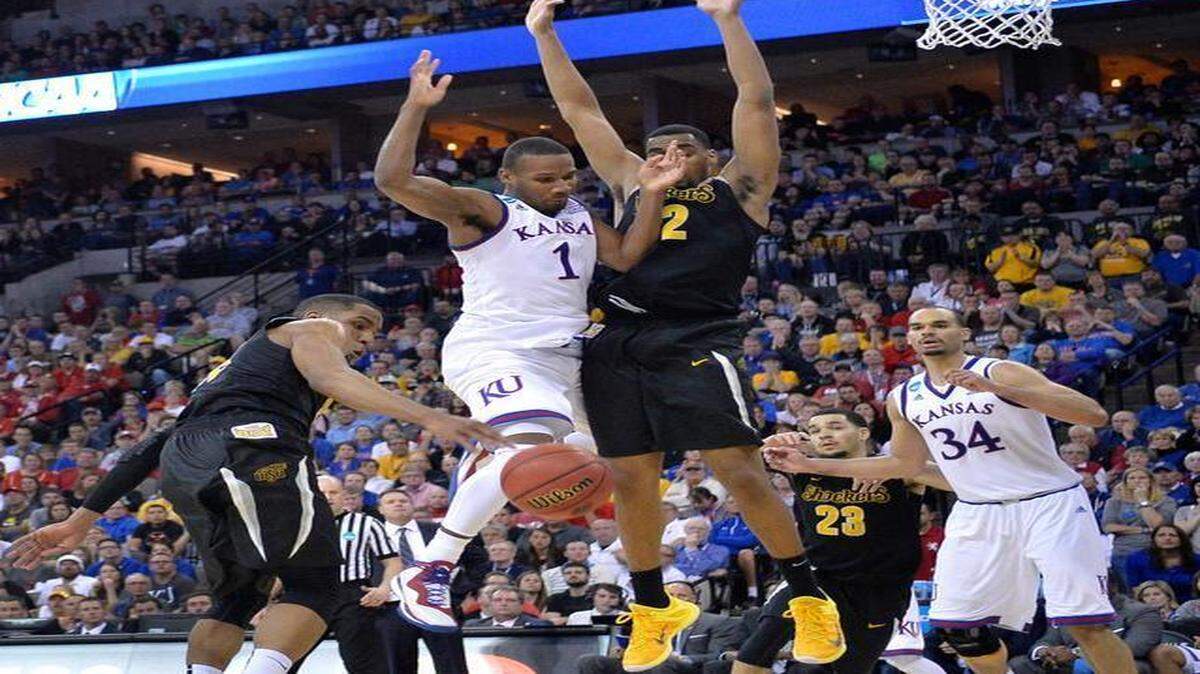 
Kansas’ Wayne Selden (middle) was stripped of the ball by Wichita State’s Tekele Cotton and Darius Carter during the second half of Sunday’s NCAA Tournament game in Omaha, Neb.
