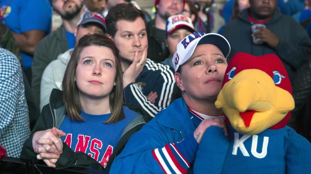 Kansas basketball fans Katie Bolton (left) of Kansas City and Tammy Richardson of Shawnee watched the big screen as the Oregon Ducks pulled ahead of the Kansas Jayhawks during game action at the NCAA's Elite Eight game at the Sprint Center.