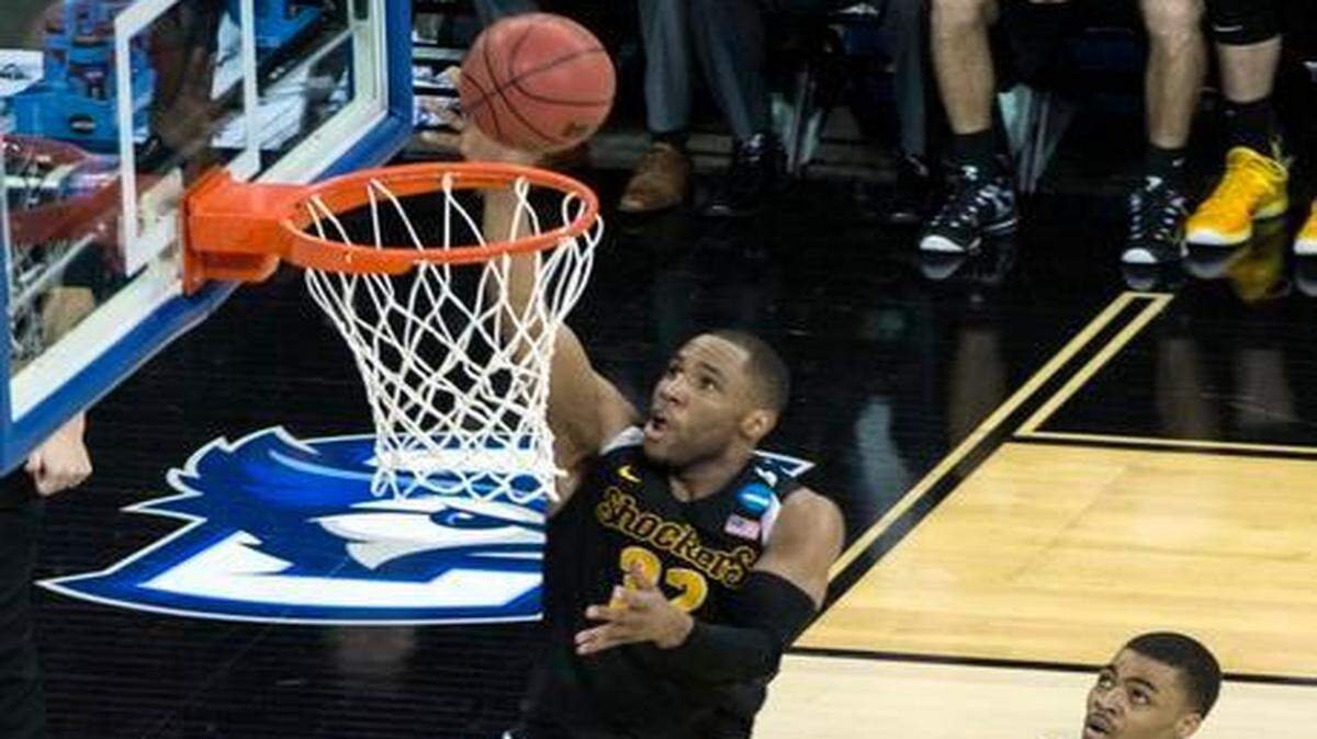
Wichita State's Tekele Cotton slips between Kansas guard Kelly Oubre and Frank Mason in the second half during Sunday's NCAA tournament basketball game on March 22, 2015 in Omaha, Neb.
