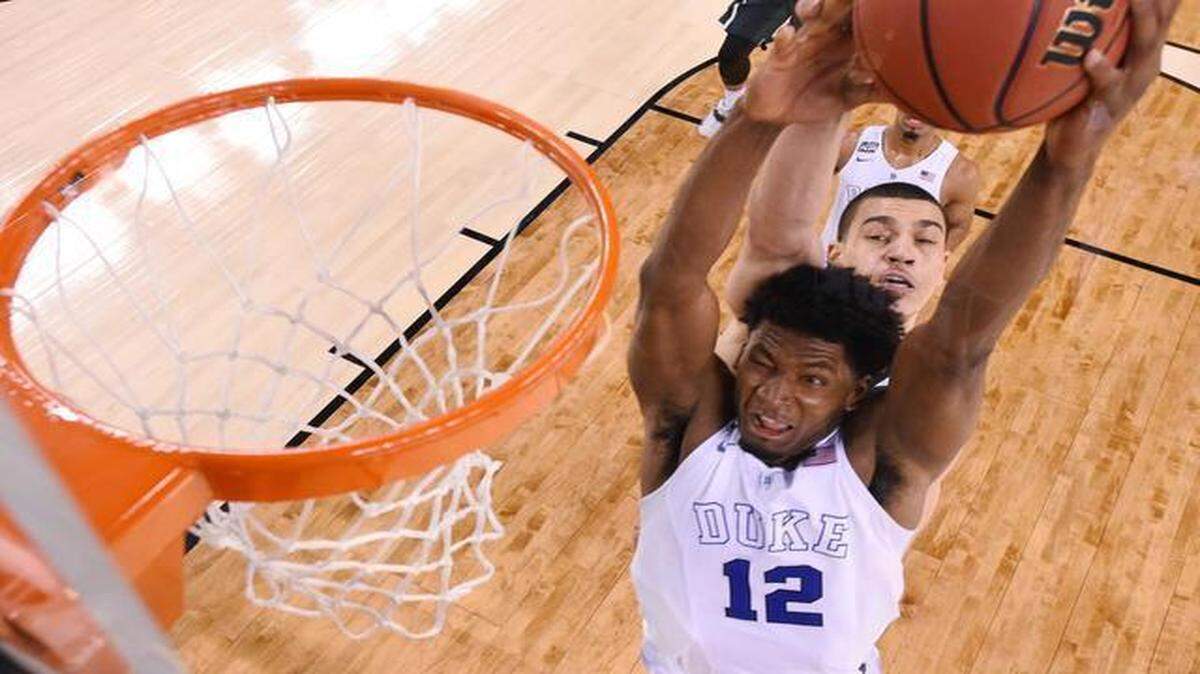 
Duke’s Justise Winslow (12) was fouled by Michigan State’s Gavin Schilling in the second half of the NCAA Final Four men’s basketball seminfinal Saturday at Lucas Oil Stadium in Indianapolis. The Blue Devils beat the Spartans 81-61 and advance to play in the national championship game Monday night.
