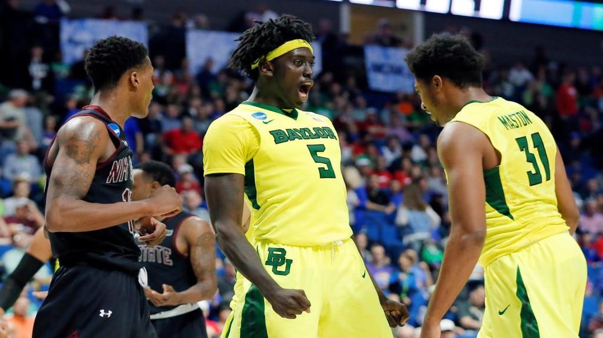 New Mexico State’s Jemerrio Jones, left, watches as Baylor’s Johnathan Motley (5) and Terry Maston celebrate a basket by Maston in the second half Friday of the Bears’ 91-73 win in the first round of the NCAA Tournament in Tulsa, Okla.