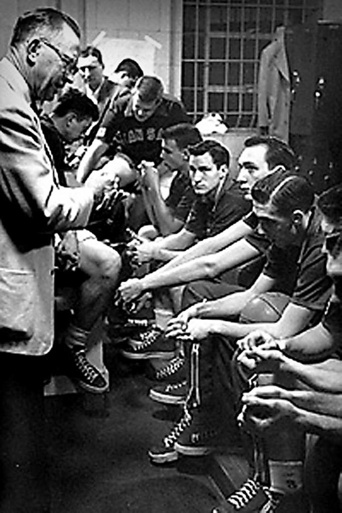 KU coach Phog Allen gives final instructions to his team before playing and beating St. John’s for the 1952 NCAA championship in Seattle. Looking at the camera is future UNC legend Dean Smith.