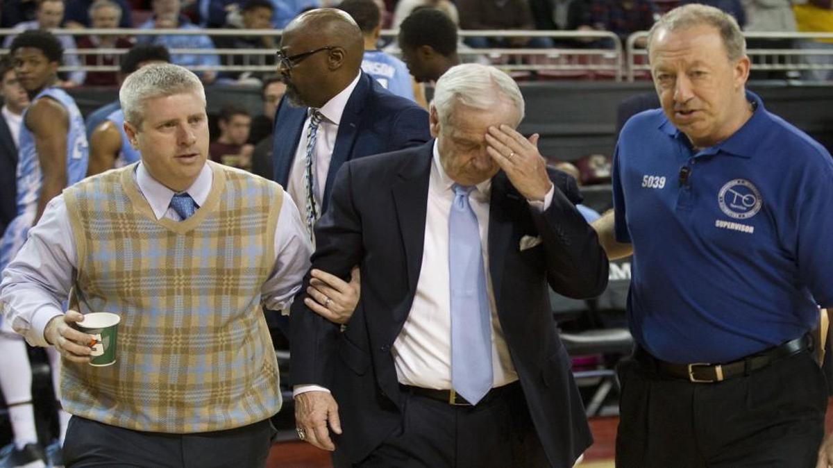 North Carolina head coach Roy Williams was escorted off the court by trainer Doug Halverson (left) and a member of the game staff early in the second half against Boston College on Tuesday.