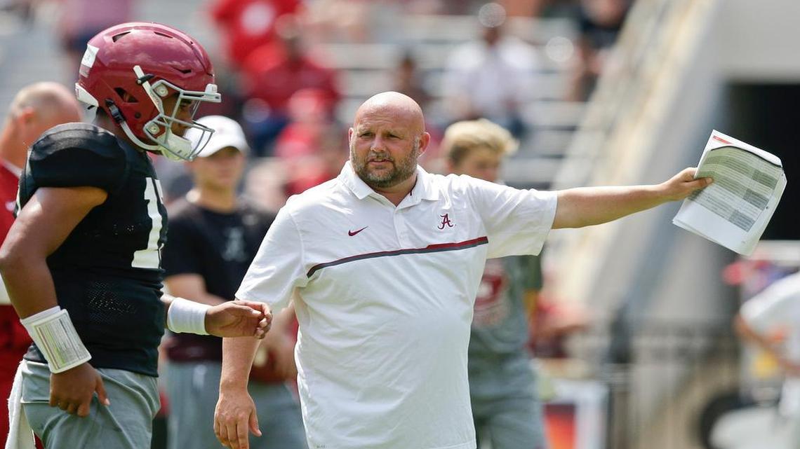 Alabama quarterback Jalen Hurts gets some instructions from offensive coordinator Brian Daboll.