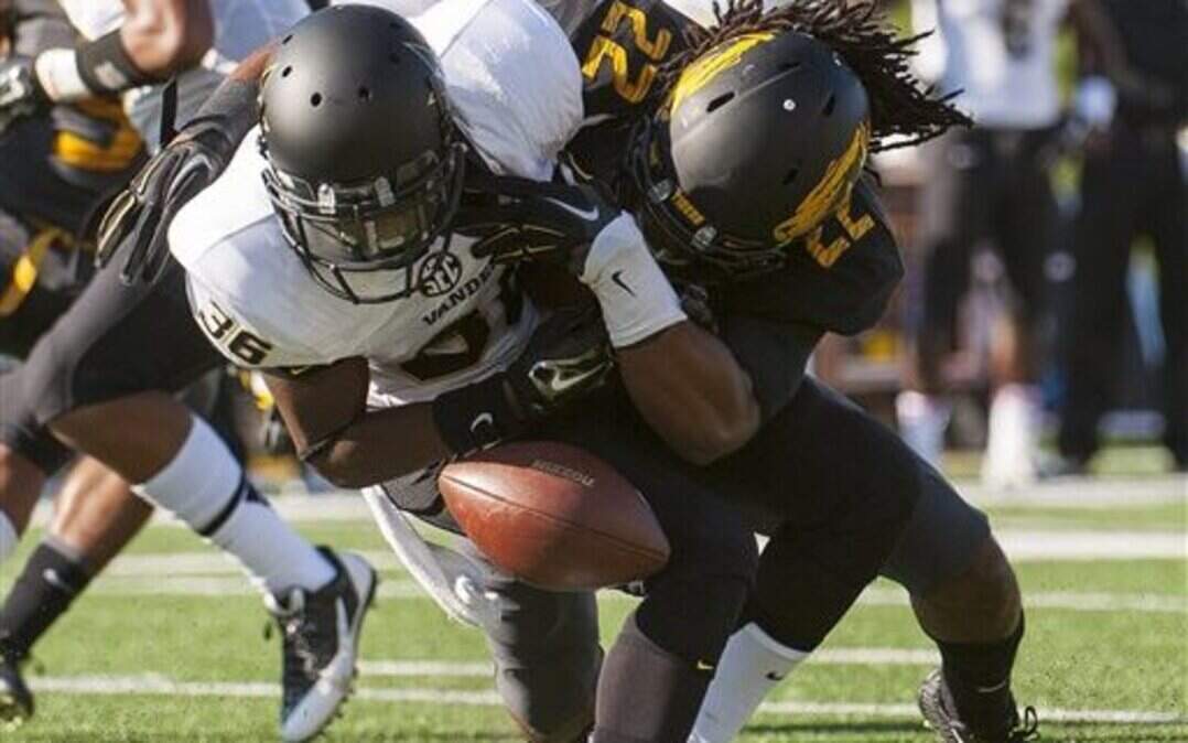 
Vanderbilt's Trey Ellis, left, is hit by Missouri's Anthony Sherrils, right, while trying to field a punt during the first quarter of an NCAA college football game Saturday, Oct. 25, 2014, in Columbia, Mo. Sherrils was penalized on the play. (AP Photo/L.G. Patterson)
