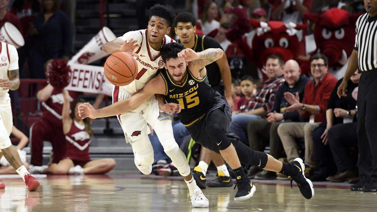 Arkansas guard Isaiah Joe (1) steals the ball from Missouri guard Jordan Geist (15) during the first half Wednesday in Fayetteville, Ark.