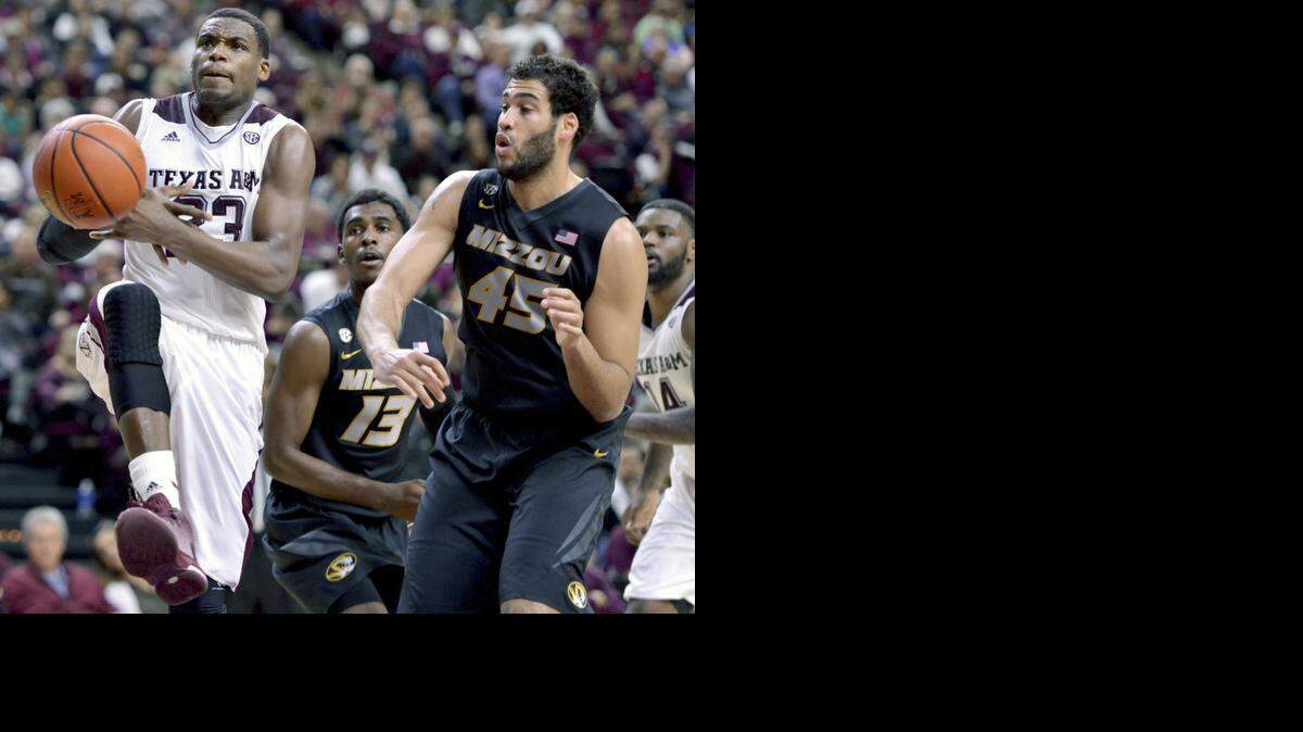 
Texas A&M’s Danuel House had the ball knocked out of his hands by Missouri forward Keanau Post during Wednesday’s game.
