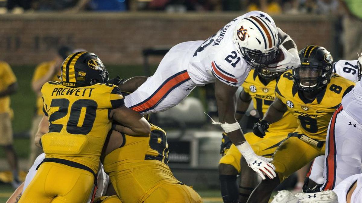 Auburn running back Kerryon Johnson went up and over for one of his five touchdowns against Missouri on Saturday in Columbia.