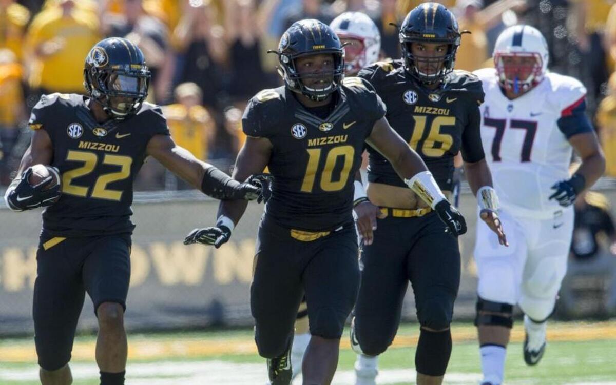 
Missouri defensive back Anthony Sherrils (22) pointed where he needed a block as linebacker Kentrell Brothers (10) and safety Brock Bondurant (16) provided an escort after Sherrils intercepted a pass in the end zone during a failed fake field goal attempt late in the fourth quarter of Saturday’s college football game against UConn at Faurot Field.
