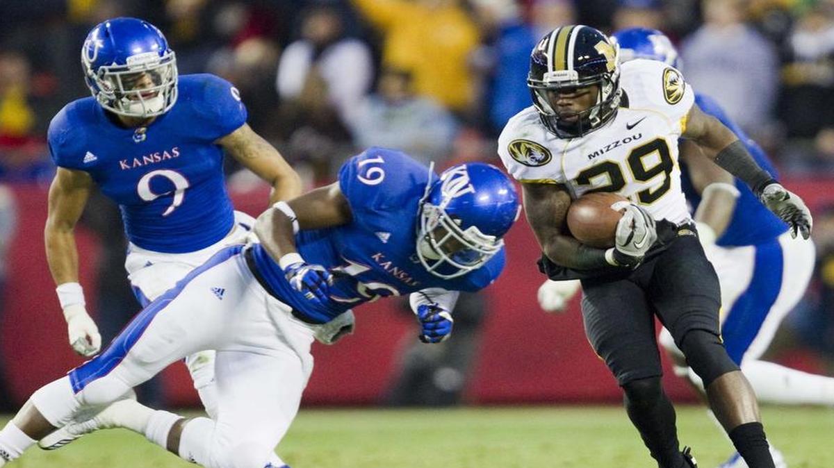 
Missouri Tigers wide receiver Jerrell Jackson (29) prepared for a hit from Kansas cornerback Isiah Barfield during the last time the schools played in football, in 2011 at Arrowhead Stadium.
