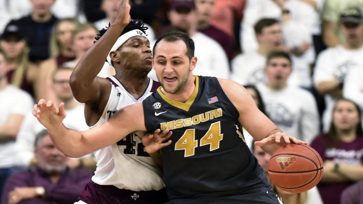 Missouri’s Ryan Rosburg (right) was guarded by Texas A&M’s Tavario Miller in their game Saturday in College Station, Texas. The Aggies beat the Tigers 66-53.