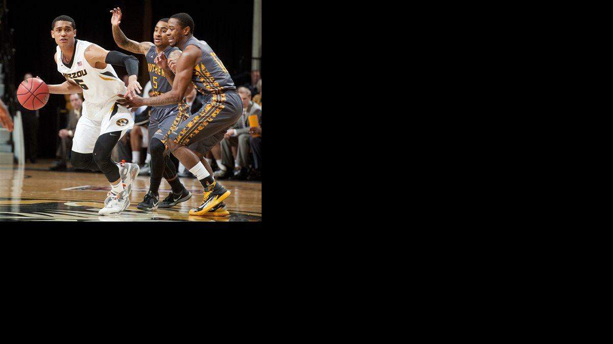 
Missouri's Jordan Clarkson (left) looked for help as he dribbled past Southern Mississippi’s Deonte Houston (right) and Neil Watson in the first half of a second-round NIT tournament game, March 23 in Columbia.
