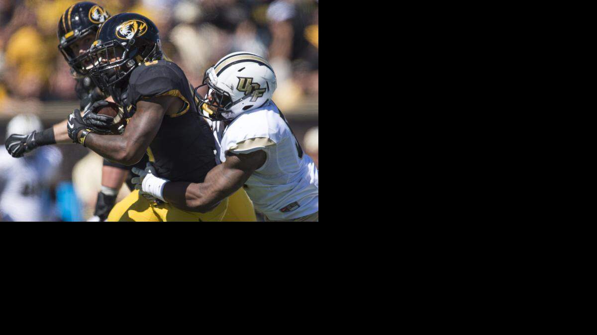 
Missouri Tigers running back Marcus Murphy (6) takes UCF Knights linebacker Troy Gray (57) for a ride in the fourth quarter during the University of Missouri and University of Central Florida football game at Faurot Field on Saturday, September 13, 2014, in Columbia, Missouri. Missouri beat Central Florida 38-10.
