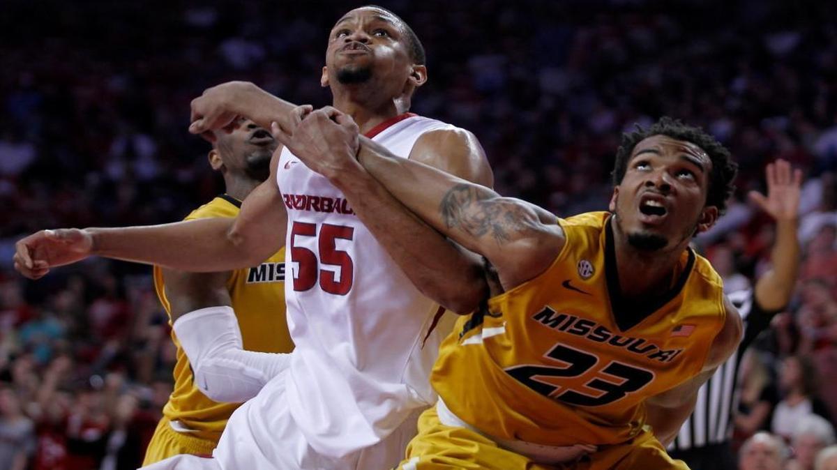 Arkansas’ Keaton Miles (55) and Missouri’s Jakeenan Gant (23) fought for rebounding position on a free-throw in the first half as the Razorbacks and Tigers played Saturday in Fayetteville, Ark.
