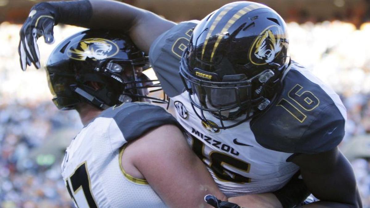 MU running back Damarea Crockett (right) celebrated with right tackle Paul Adams after scoring a touchdown during the first half of Saturday’s game against Tennessee in Knoxville.