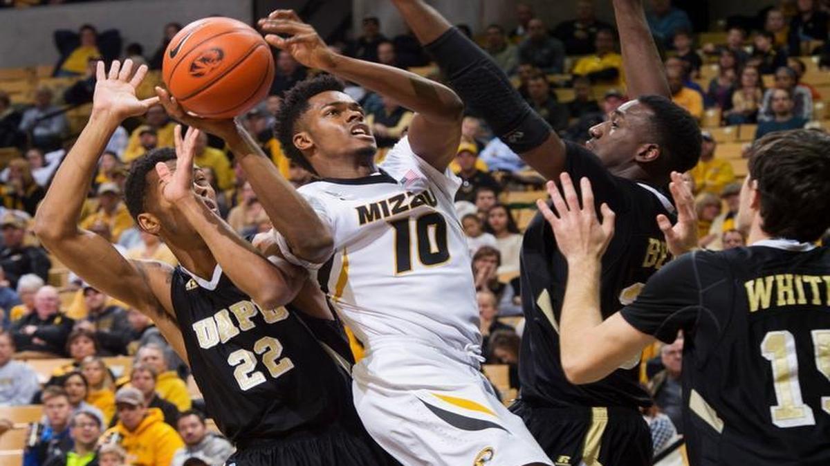 Missouri’s K.J. Walton (center) shot as he was defended by Arkansas-Pine Bluff’s JoVaughn Love (left), Trent Whiting (right) and Devin Berry in the first half Tuesday night at Mizzou Arena in Columbia.