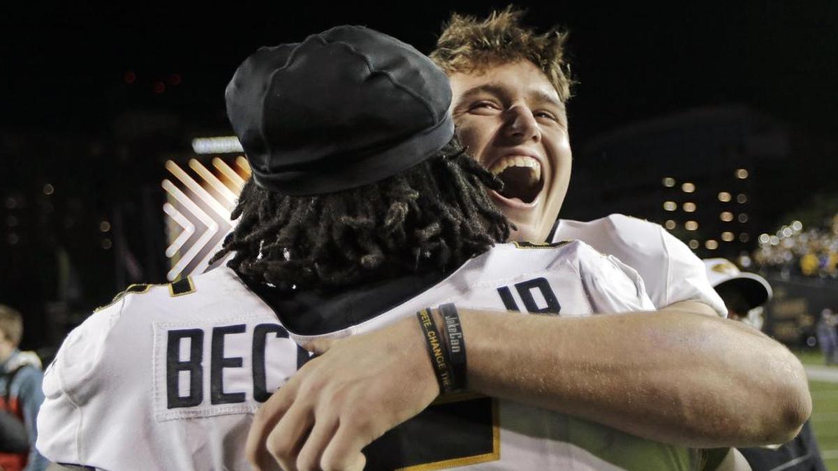 Missouri quarterback Drew Lock hugged defensive lineman Terry Beckner Jr. (5) after the Tigers defeated Vanderbilt.