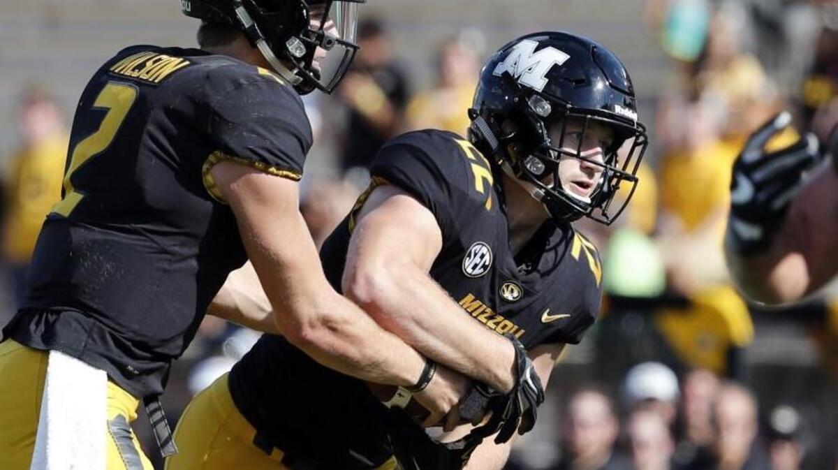 Miege grad Dawson Downing, right, has been proving he belongs at his position of choice: running back.